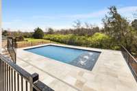 Another view of the pool area showing generous yard space to the left