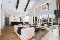 Another view of this warm and sun-filled open concept kitchen / LR / breakfast room which leads to the covered porch overlooking the pool