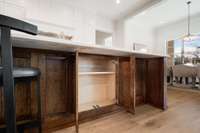 Kitchen island has hidden cabinets under the barstools creating generous and convenient additional storage