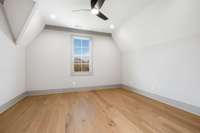 Secondary bedroom with vaulted ceilings and gorgeous hardwood floors