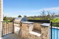 Outdoor grilling area with designated space to add a smoker