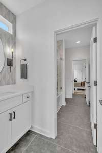 This Jack and Jill bathroom is beautifully finished with upgraded tile, fixtures and great lighting