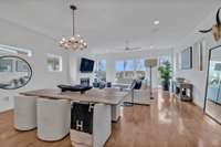 The inviting living room has ceiling speakers and wonderful lighting.  The windows are positioned in such a way to provide great natural light but plenty of privacy.