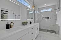 Gorgeous tile, sleek quartz countertops and an oversized shower complete the space.