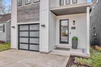 The attached one garage makes urban living a breeze.  The front entrance features a beautiful wood beamed ceiling and custom glass door.