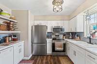 Newly installed cabinets, stylish backsplash, and updated appliances.