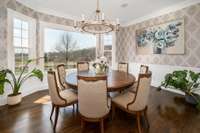 The beautiful formal dining room adjacent to the kitchen is brightened by an enormous bay window overlooking the lawns outside. Enjoy home-cooked meals & holiday gatherings in this space.