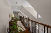 Upstairs hallway is an indoor balcony that overlooks the spacious kitchen area below! Vaulted ceilings and 2nd story windows brighten this space and provide an element of luxury to this relaxing space