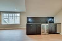 Upstairs wet bar with fridge and ice maker