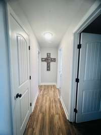 Hallway leading to bedrooms and baths.  There is also a walk in closet off the hallway for extra storage.