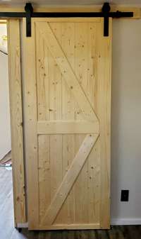 Brand new farmhouse door has been installed in the primary bedroom.