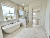 Level 3 Tile Shower Surround to Ceiling & 12x24 Ceramic Tile Floor in Primary Bath.