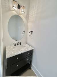 30" Powder Bath Sink Vanity w/ Integrated Sink & Countertop. Elongated Commode in All Bathrooms.