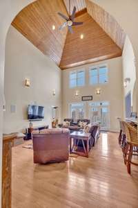 Welcoming and inviting great room with vaulted ceilings with impeccable cherry oak woodwork detail