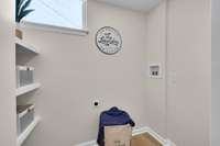 Laundry room with additional custom wood shelving