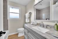 Full hallway bathroom complete with custom vanity and stunning tile hand picked for this home.