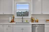 Imagine this kitchen sink with the view of your very own backyard and detached garage.