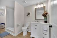 Custom primary bathroom with granite countertops and laundry room.