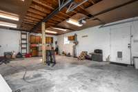 Iniside the 2 car garage/ shop/ hobby area w/ concrete floor