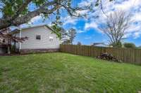 Back yard has wooden fence