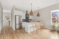 expansive kitchen and gas range with designer tile backsplash