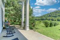 A slice of tranquil Middle Tennessee serenity! The grand columned front porch evokes the home's historic past, and the incredible view across the gently rolling wooded hillside is simply breathtaking.