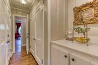 There is ample storage space throughout -- including these two wide closets and built-in cabinets in the hallway to the laundry room.