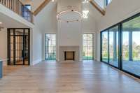 Grandiose Great Room with vaulted ceiling and wood-burning fireplace