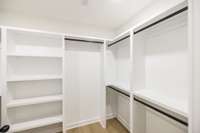 huge closet with custom wood shelving