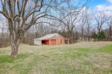 This home not only has an attached 2 car garage, but also a detached oversized 1 car garage with carport areas on each side!