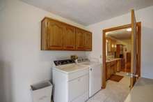 LARGE laundry room with cabinets for storage! The pedestrian door on the side of the home enters into the laundry room!