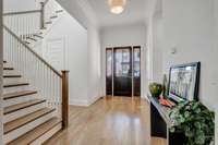 The large foyer serves as an excellent transitional space, seamlessly connecting the front entry with the other rooms of the home