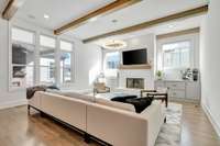 Natural light floods the living area.  A cozy, wood burning fireplace and built-in cabinetry elevate the functionality of the space.  *The pictured chandelier does not convey with the home.