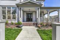 The stately entrance adds an elegant touch with decorative brackets accenting the columns