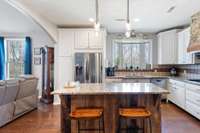 Kitchen has granite counters and an island