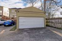 Enhancing security, the oversized carport features a garage door for convenient access from the alley, along with extra parking.