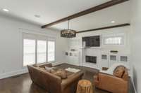 Second fireplace in the home, surrounded by lovely built in storage and blinds