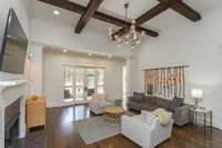 Living room with fireplace and beautiful craftsman details overlooking pool area