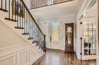 Light-filled two-floor entrance with polished hardwoods and elegant wainscoting