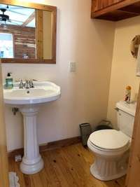 Cabin has hardwood floors throughout the main living space and this full-bath