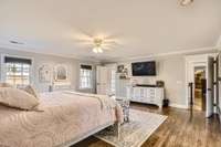 Gleaming hardwood floors, recessed lighting and ceiling fan in this 19x19 upstairs bedroom