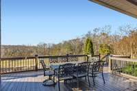 The freshly painted deck is the place to enjoy the panoramic view of the lovely tree-lined property