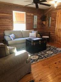 Cozy living room with rustic wood finishes and comfy seating to relax and chill