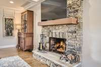 This impressive stone fireplace has a newly installed remote-controlled gas insert