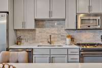 Gas cooking and tile backsplash along