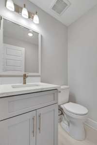 The half bath on the first floor offers essential amenities within a compact yet stylish space, featuring a modern design and convenient accessibility for guests and residents alike. 6206A Morrow Rd  Nashville, TN 37209