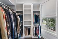 The large custom closet offers practicality, aesthetics, and functionality.