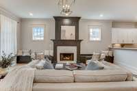 Spend time in the oversized elegant living room with custom built-in's and fireplace hand hewned molding.