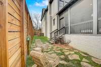 Manicured green space with a towering wood privacy fence