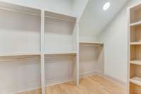 Not one but two owner suite closets with custom wood built-ins